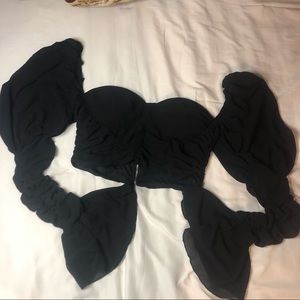 cropped long, puffed ruffled sleeve with flair end. Runs a bit small.